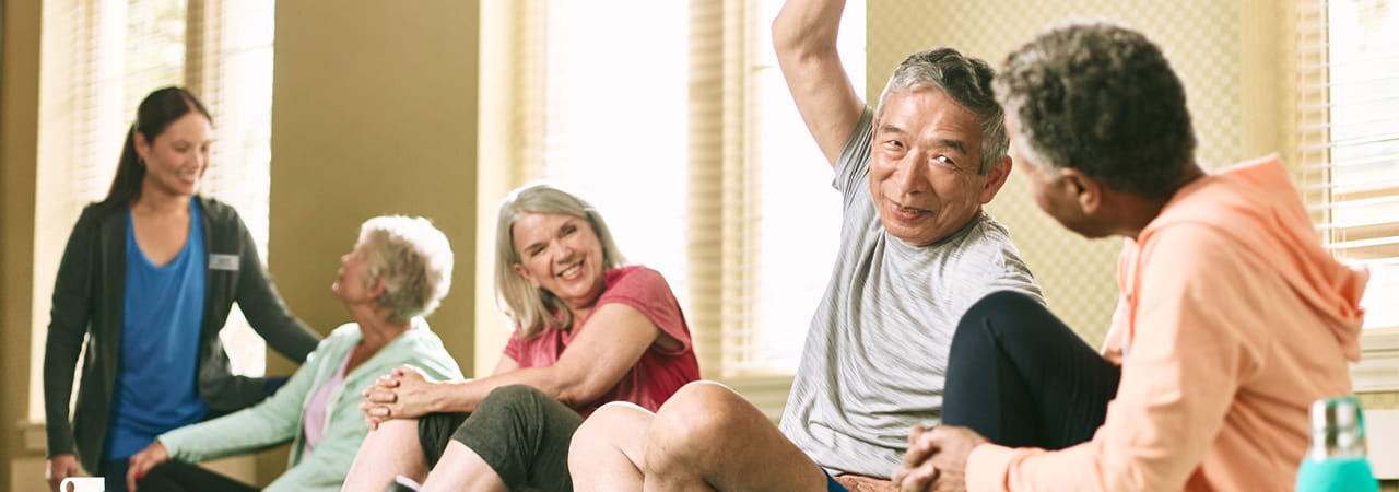 Residents stretch and smile in a group workout setting