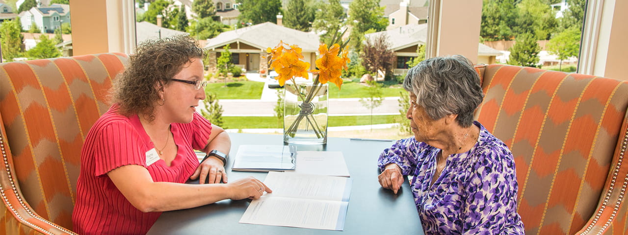 Vi at Highlands Ranch staff member talks to senior resident