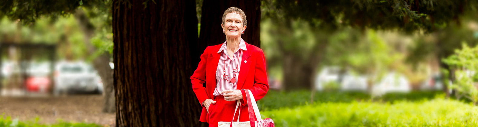 Vi at Palo Alto resident Amber Henninger stands outside in her Cardinal red outfit.