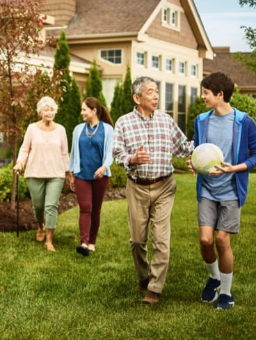 A multigenerational family outside a Vi at The Glen villa