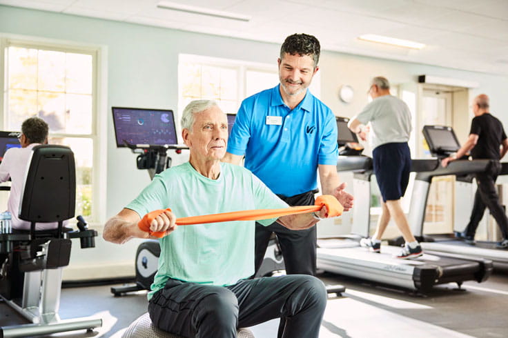 A man works out with a personal trainer at Vi.