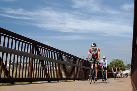 Vi's Easy Riders cycle across a bridge.
