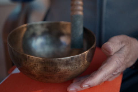 A resident holds a meditation bowl.