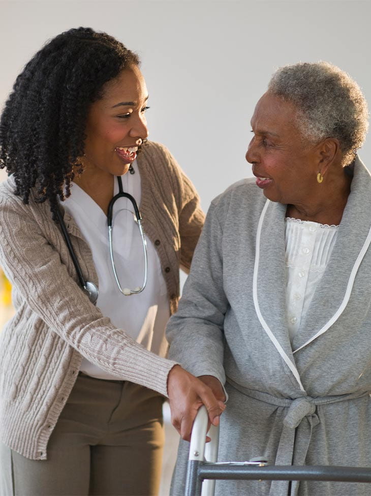 Woman and nurse walking.