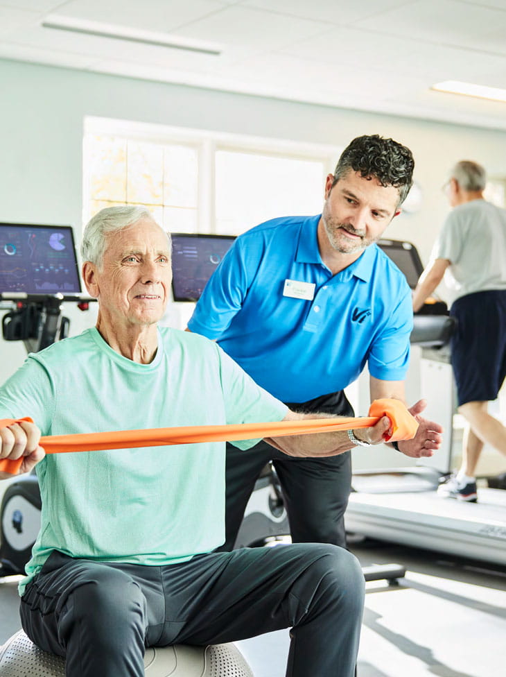 A man works out with a personal trainer.