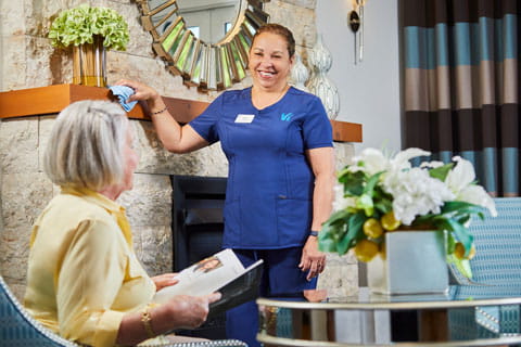 An employee stops to chat with a resident.