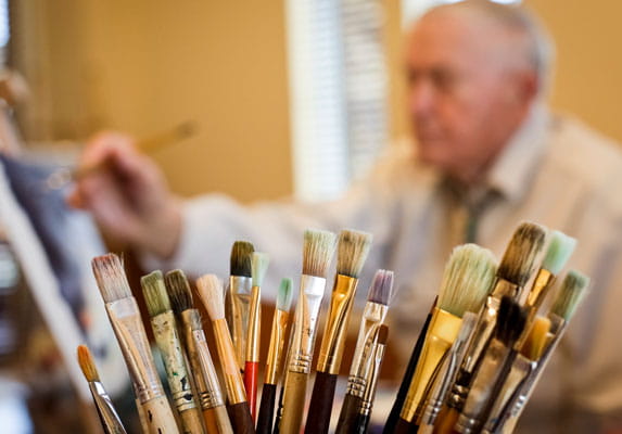 A bucket of paintbrushes.