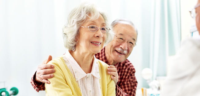 A man and woman talk to a doctor.