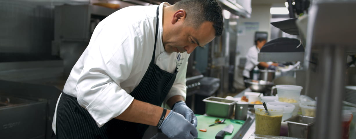 Executive Chef Azmitia prepares food in the kitchen.