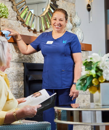 A Vi employee stops and chats with a resident.