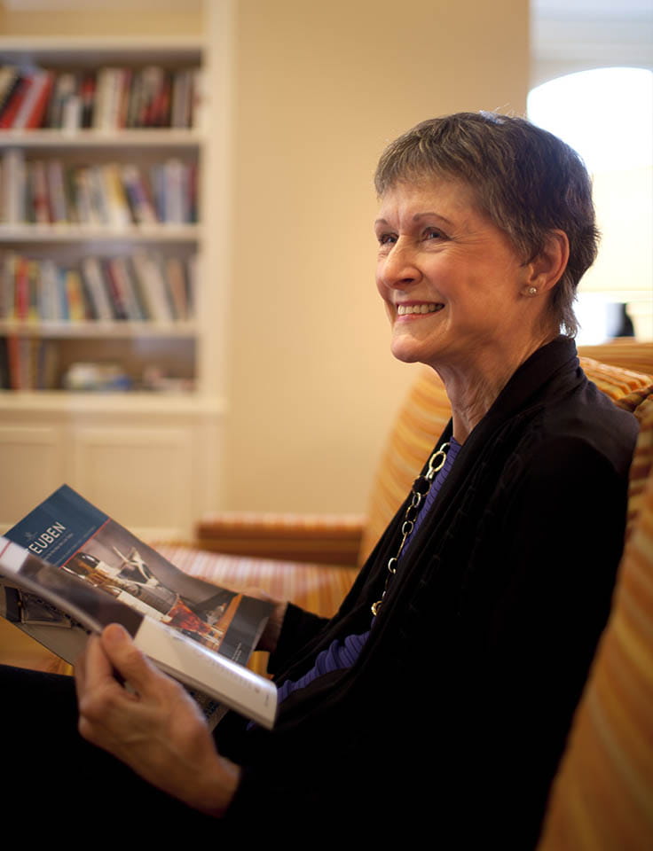 A resident reads in the library at Vi at Grayhawk.