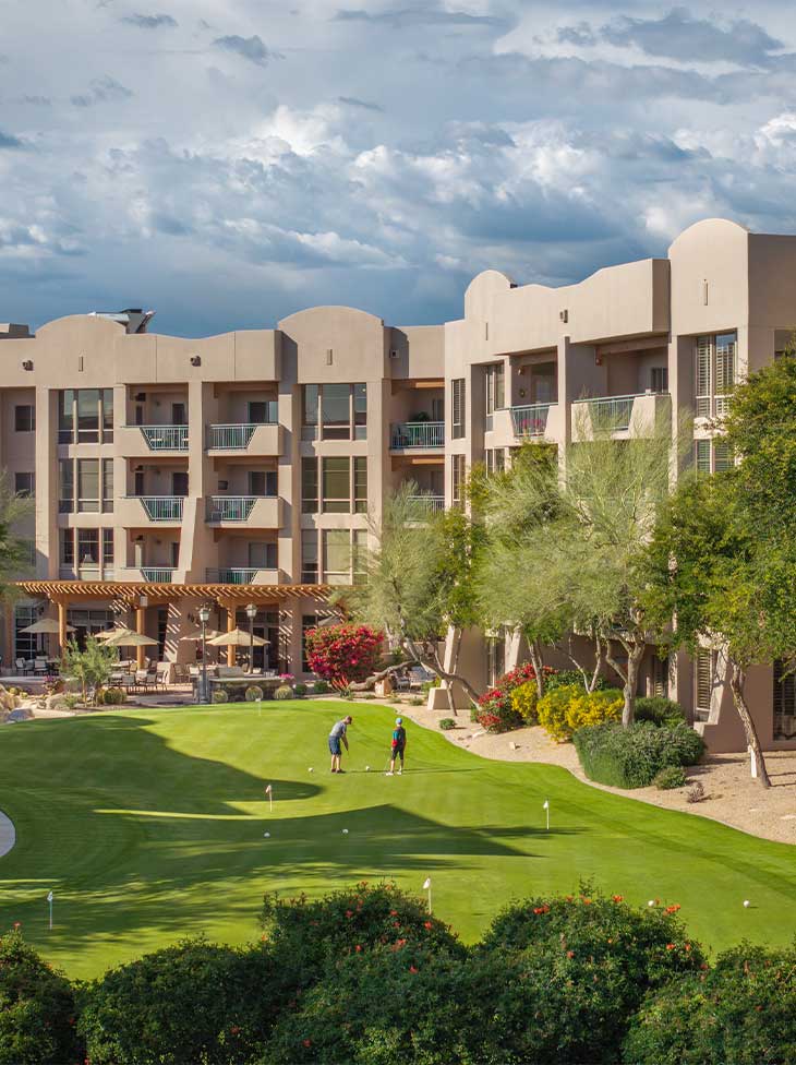 Two people playing golf at Vi at Grayhawk. 