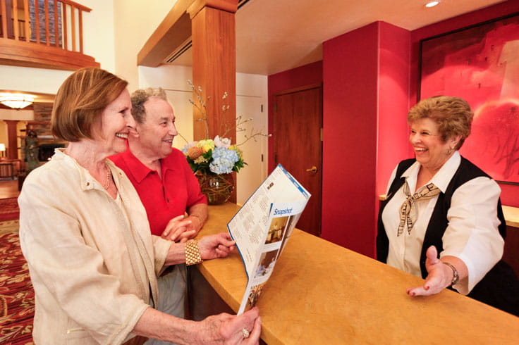 A front desk worker chats with residents.