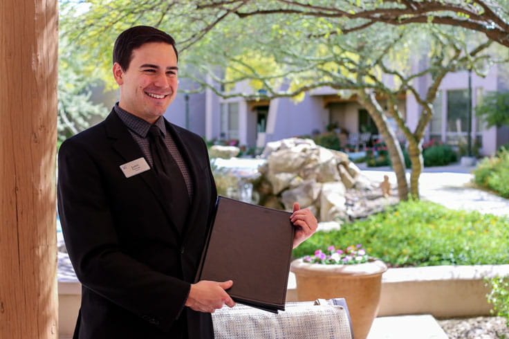 A server holds a menu.