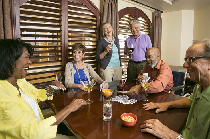 Residents laugh together over a game