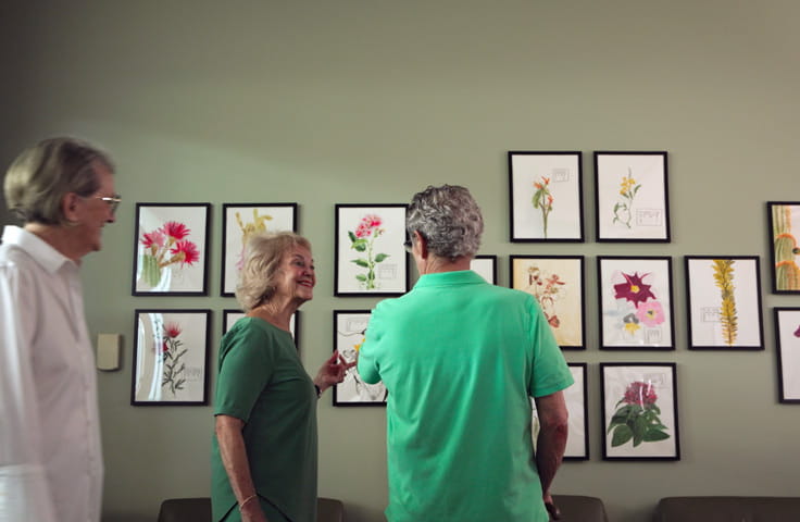 A group of Vi at Grayhawk resident artists view their work on display at the Appaloosa Library.