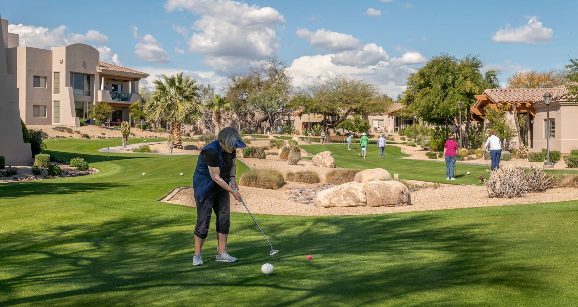 A group of residents use the putting course.