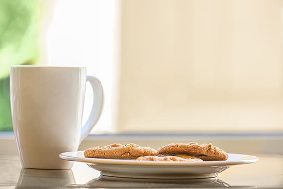 A cup of coffee and cookies. 