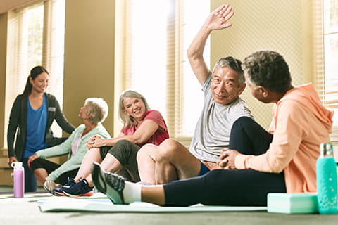 Group of people sitting and stretching. 