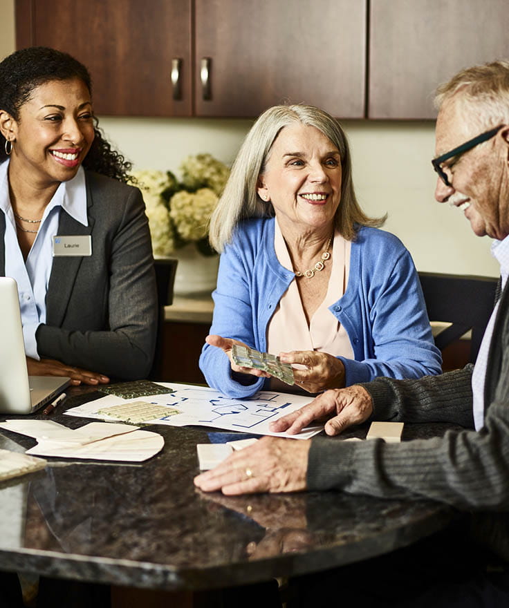Sales employees talking and smiling.