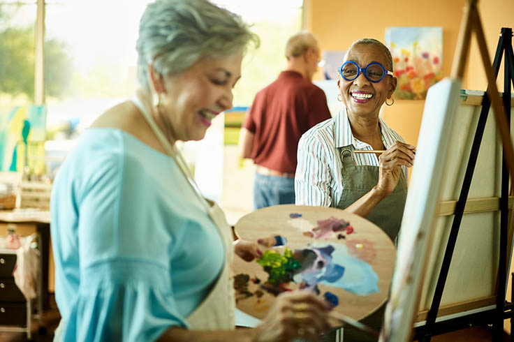 People painting and smiling. 