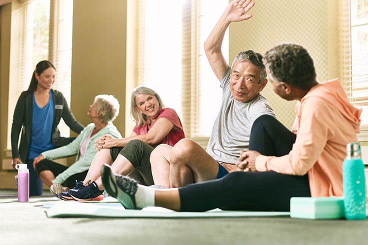 Group of people sitting and stretching. 
