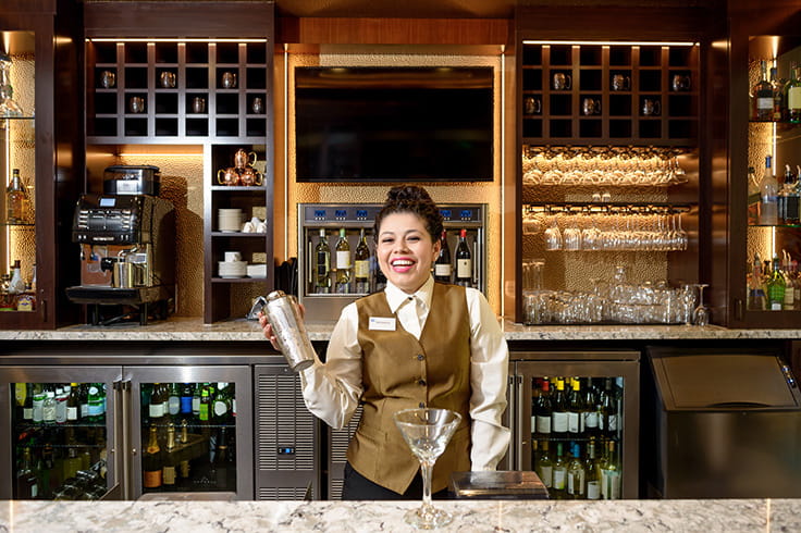 Woman bartender making a drink. 