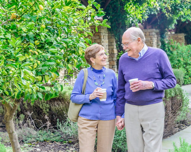 A couple walks along the paths at Vi at Palo Alto.