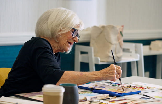 Resident Sherill Heron paints in the art studio.