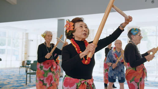 Eva leads class participants in a dance.