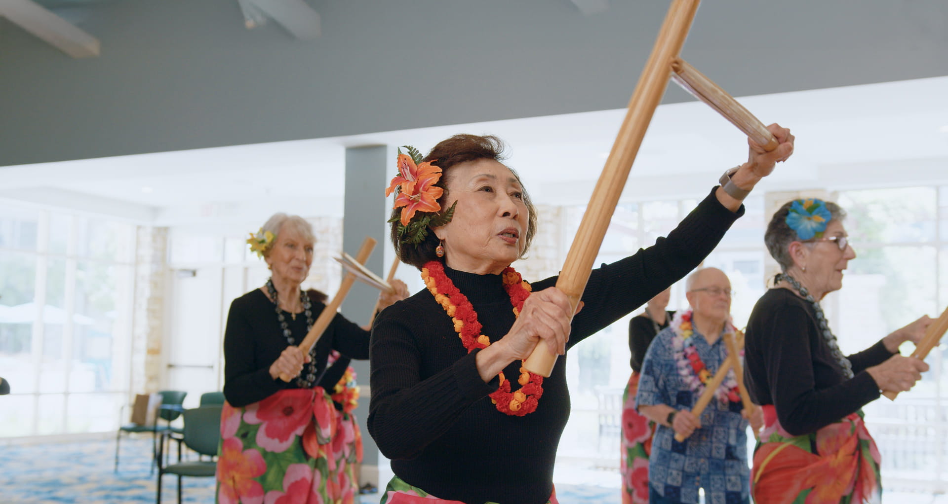 A resident-led group practices hula.