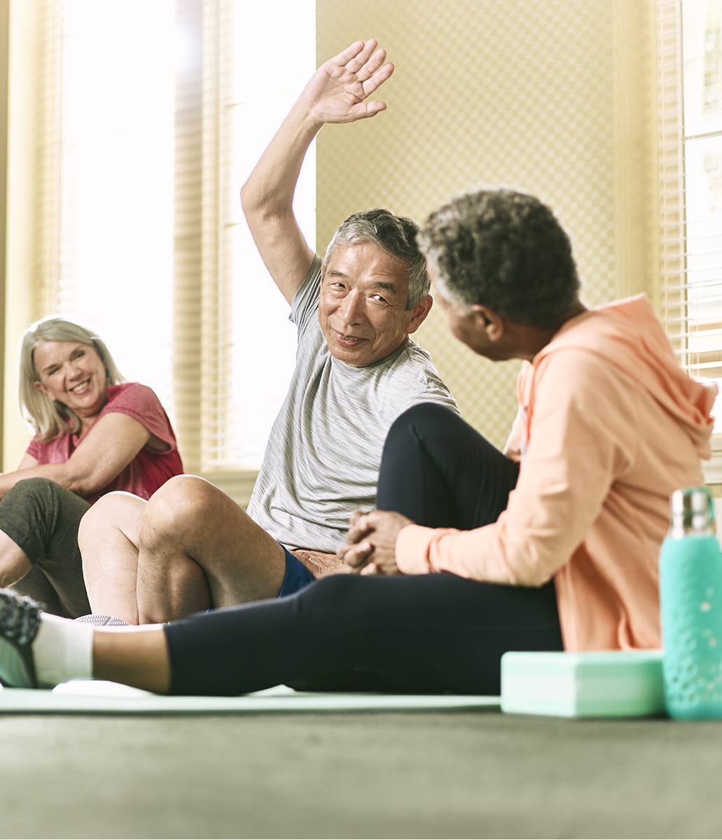 People sitting down stretching.