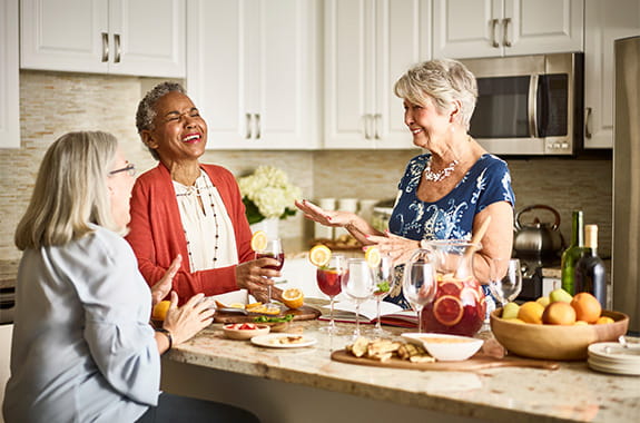 Women drinking sangria in kitchen. 