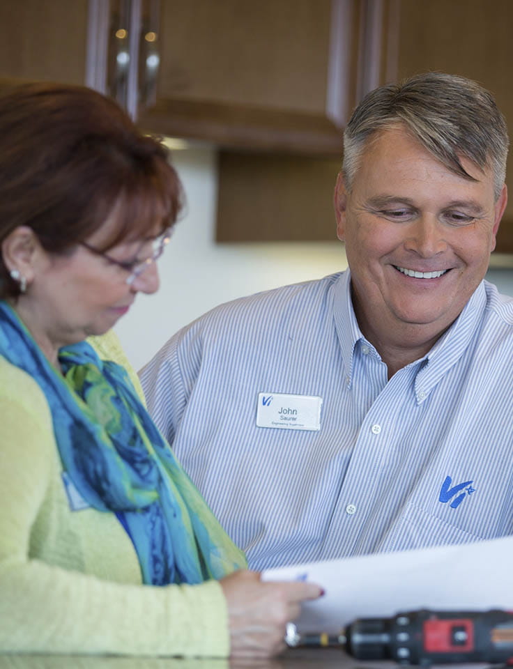 A staff member reviews a document with someone