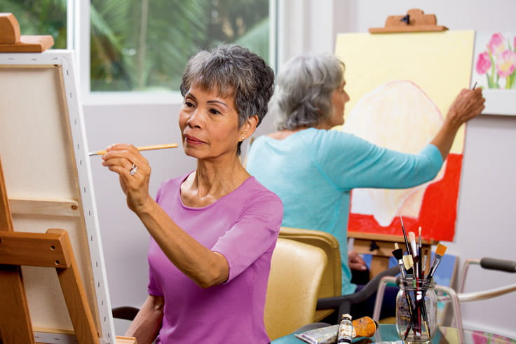 A woman painting in art class.