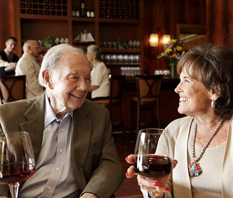 Residents enjoy a glass of red wine at America’s Cup restaurant. 