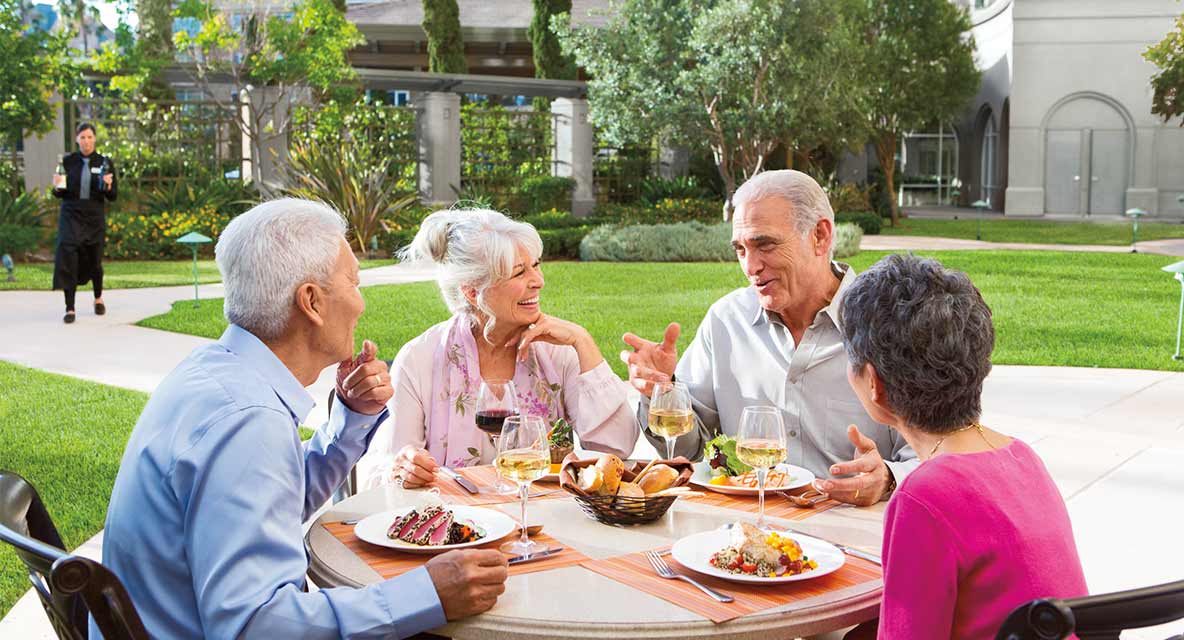 Two couples enjoy a meal al fresco at Vi at La Jolla Village.