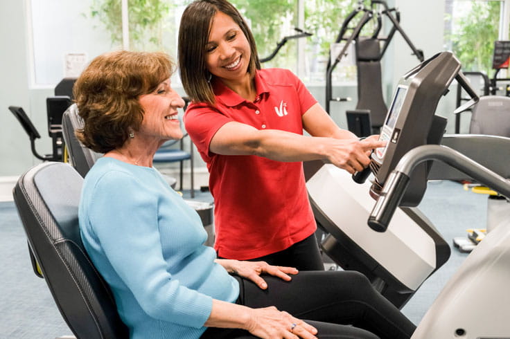 A woman works out with a personal trainer at the community.