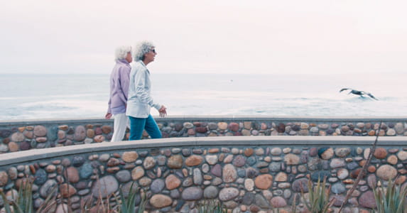 Two women walk at Vi at La Jolla Village's walking club.