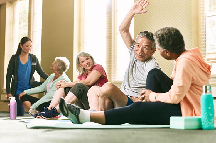 Residents stretch in the gym.