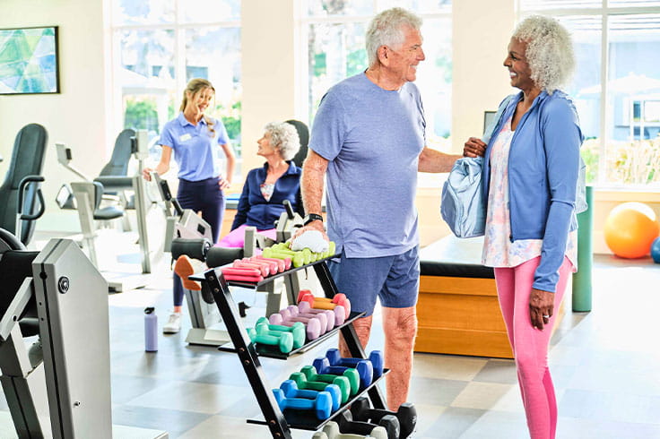 A man and women talking in a fitness center.
