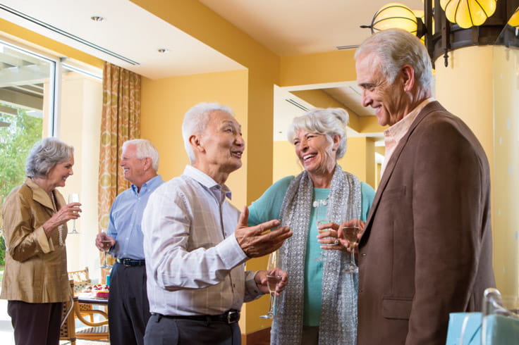 People smile and laugh at an event.