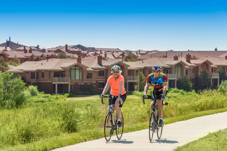 Residents ride their bikes on the trails in and around Vi at Highlands Ranch.
