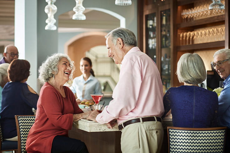 A man and women talking at the bar.