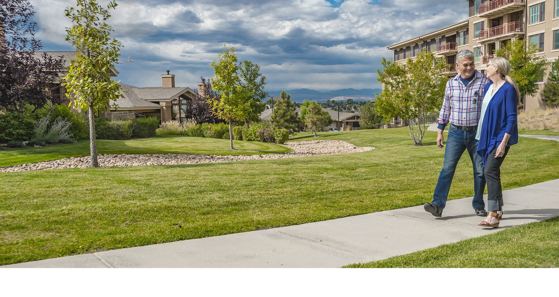 A man and woman walk on the paths around Vi at Highlands Ranch.