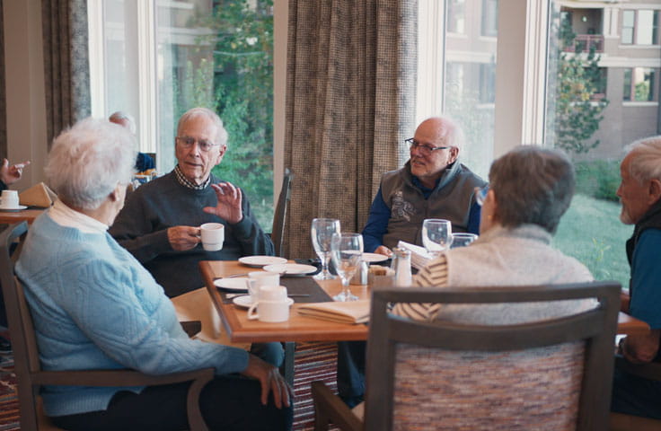 Members of the meditation club socialize over coffee.