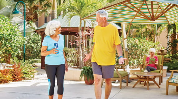 A man and woman in activewear walk outside at Vi at Lakeside Village.