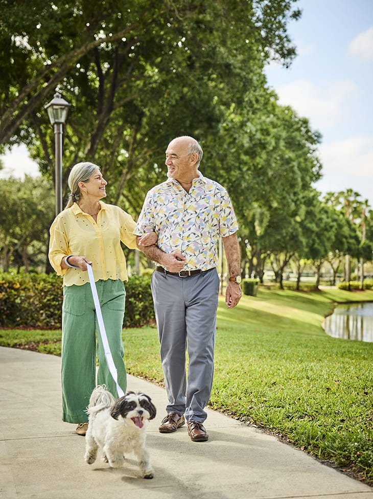 A couple walking their dog. 