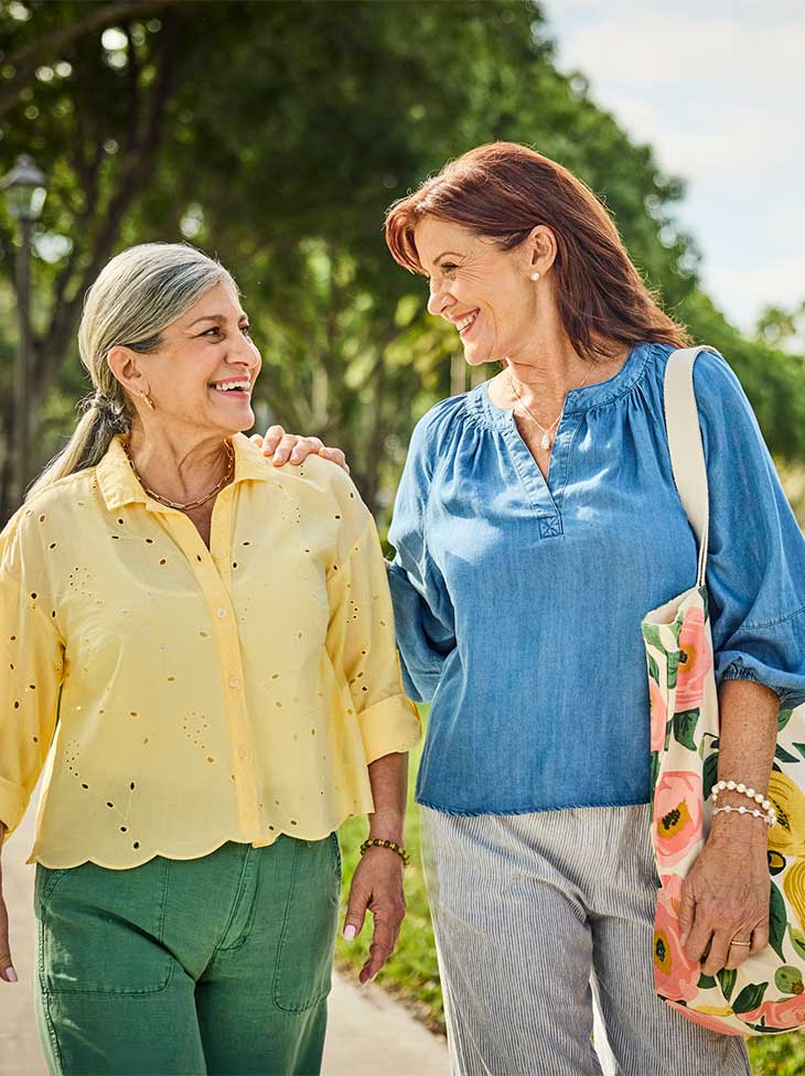 Two women walking outside. 