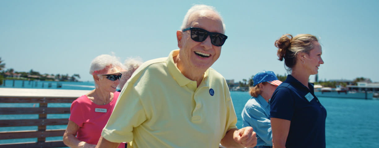 A group walks on the pier at Lake Osborne.